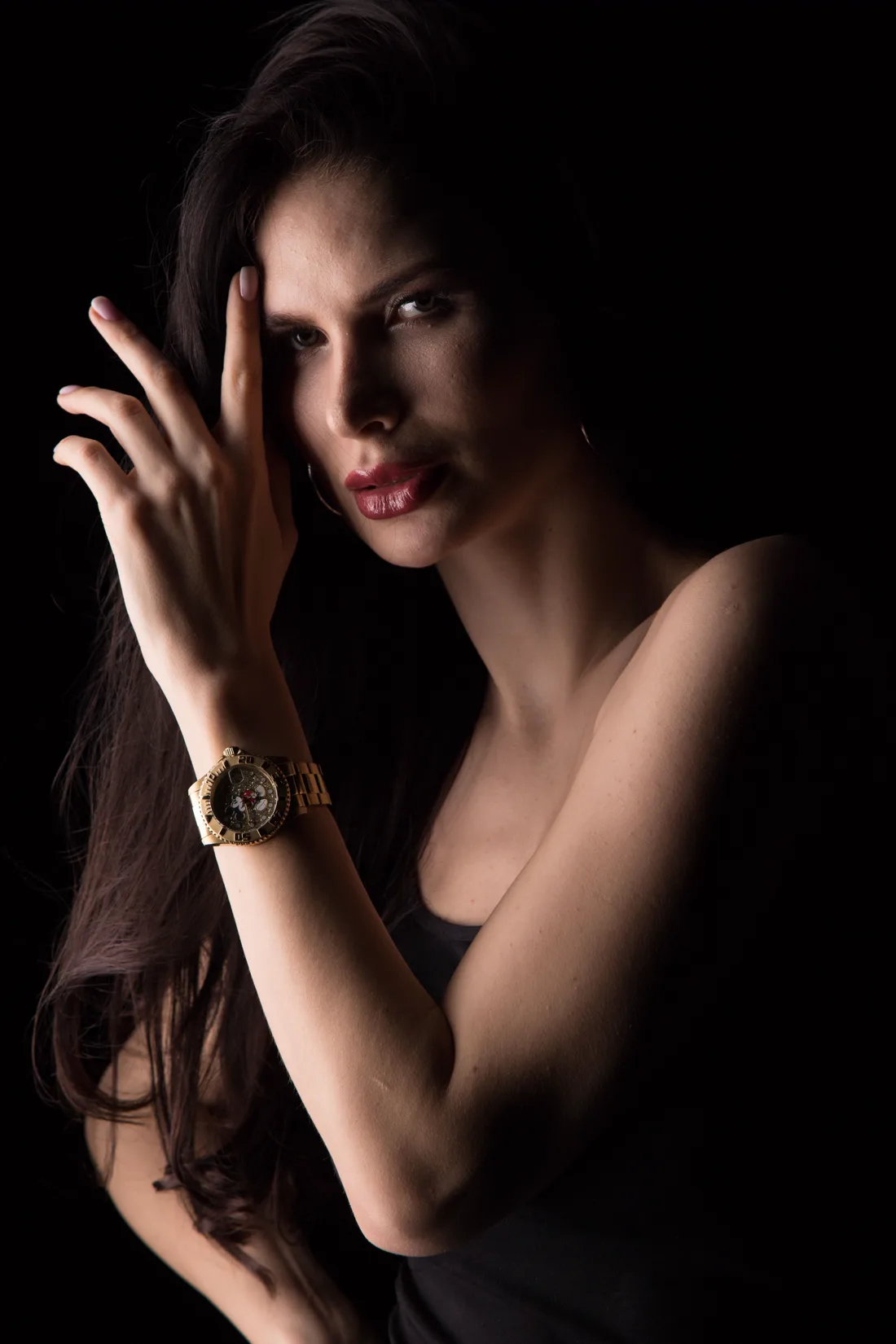 An elegant figure in low gold light, a watch at the wrist — Cartier is as much a jeweller as a watchmaker, and artistry is the through-line