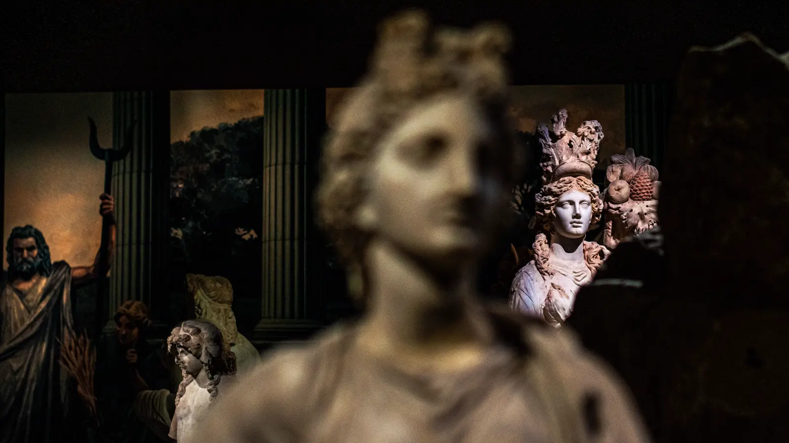 Classical marble sculptures lit in a dark museum gallery — in 2026 the Cartier Cheich is treated less like a watch than a work of art