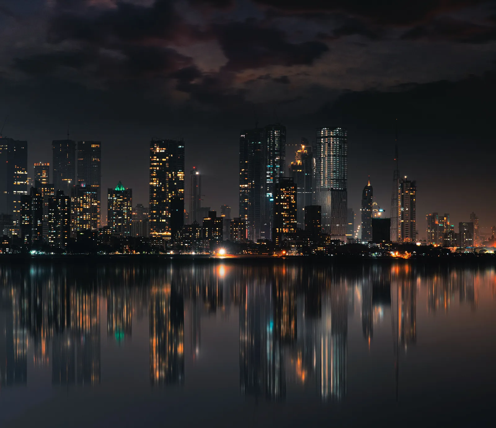 The Mumbai skyline at night reflected in still water — India's luxury-watch market at an inflection point