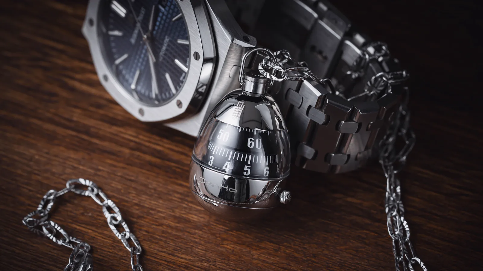 A steel Audemars Piguet Royal Oak with a blue dial on dark wood — the hyped steel sports watch at the centre of the 2026 market split