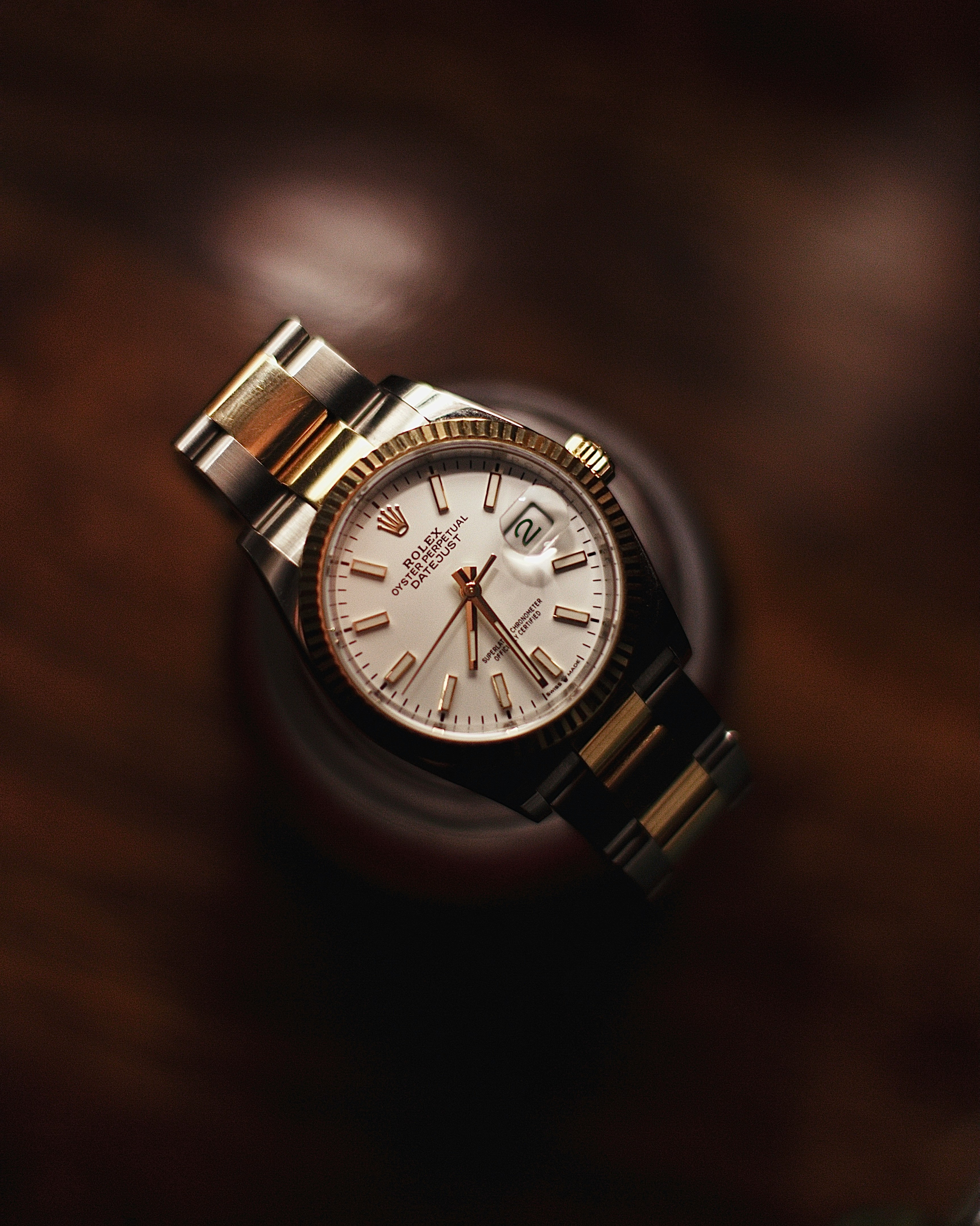 A two-tone Rolex Datejust with a white dial and fluted bezel