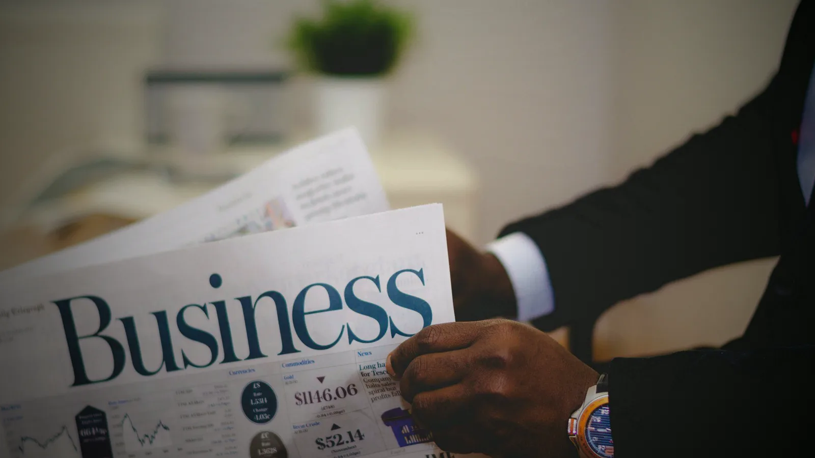 A suited reader with the business and markets pages open, a watch on the wrist — reading what a viral collaboration did to the real watch market